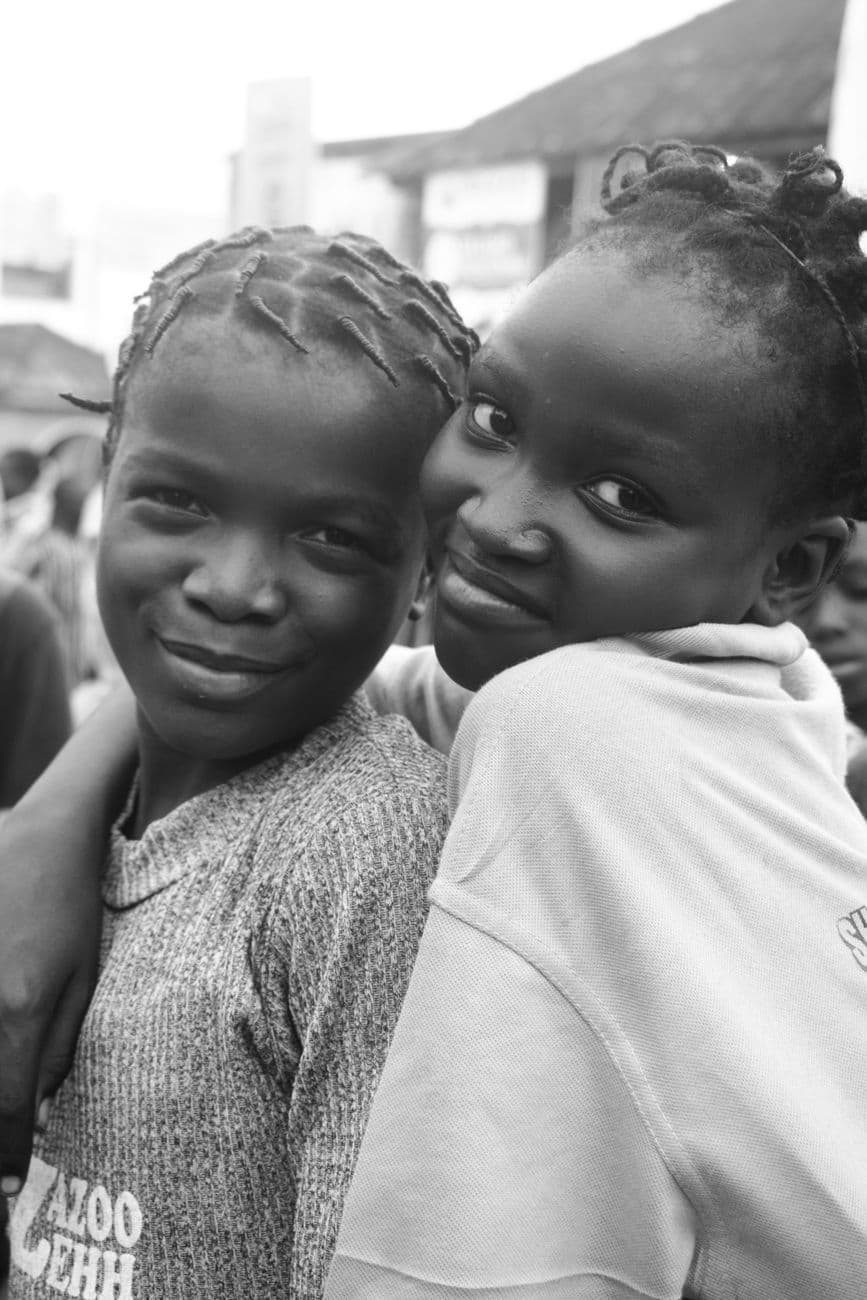 Two girls smiling in grayscale